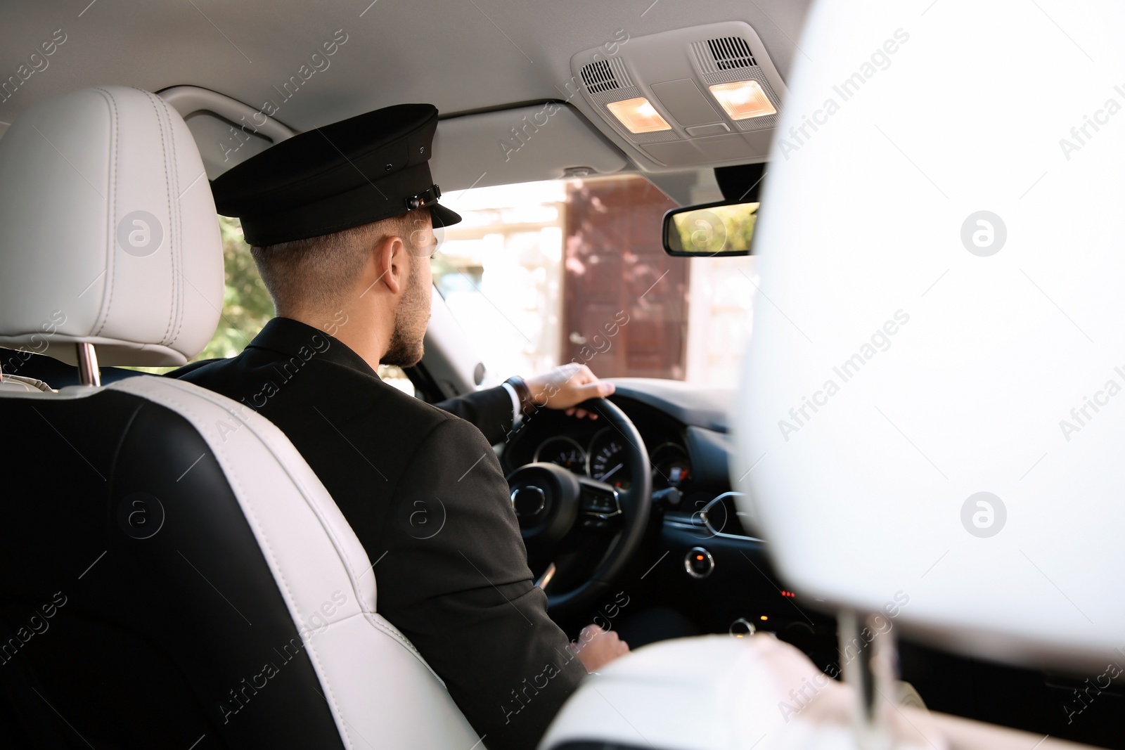 Photo of Young driver in luxury car. Chauffeur service