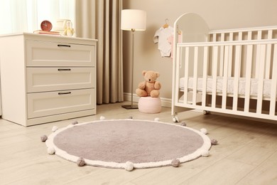 Photo of Baby room interior with modern furniture and soft rug