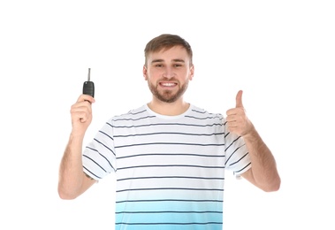 Photo of Happy young man with car key on white background. Getting driving license