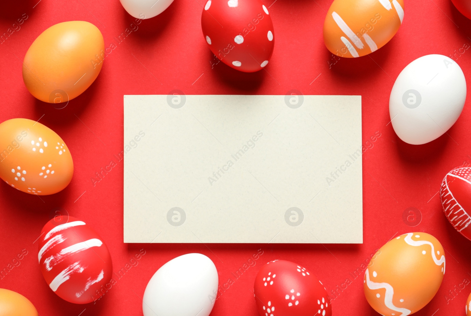 Photo of Flat lay composition of painted Easter eggs and card on color background, space for text