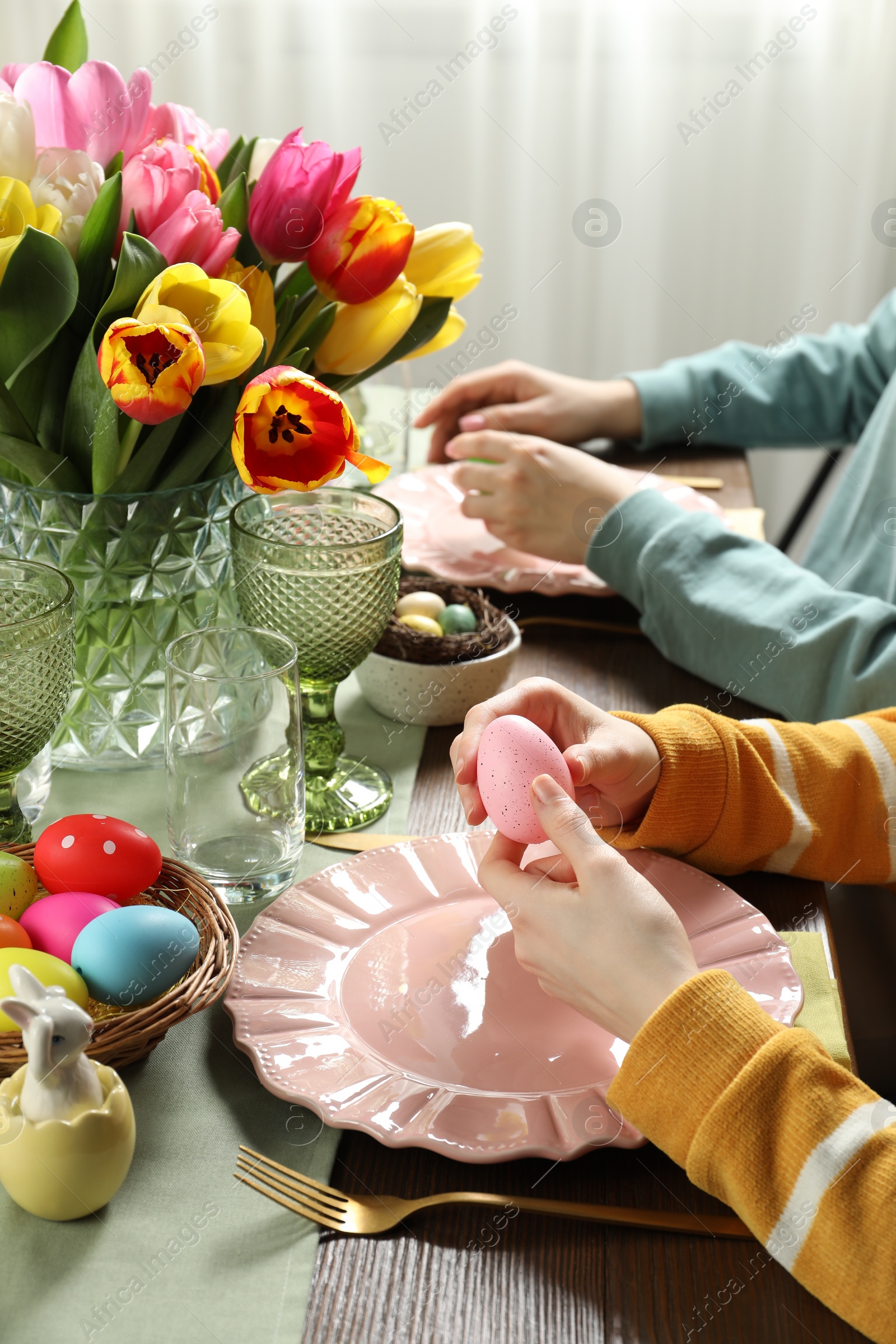 Photo of Festive table setting. Women celebrating Easter at home, closeup