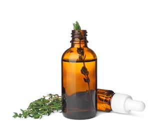 Bottles with thyme essential oil and fresh herb on white background