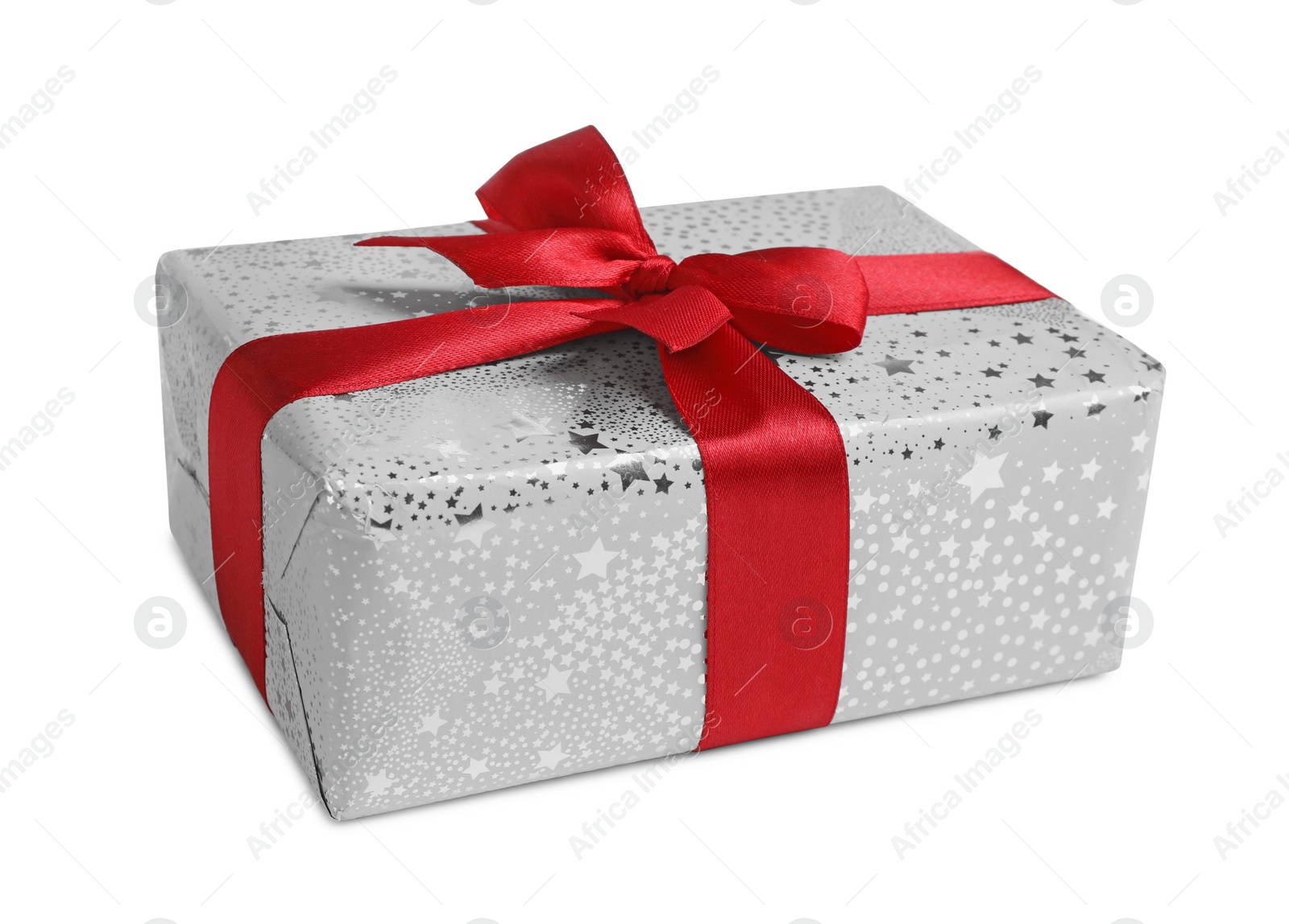 Photo of Christmas gift. Box wrapped in star patterned paper on white background