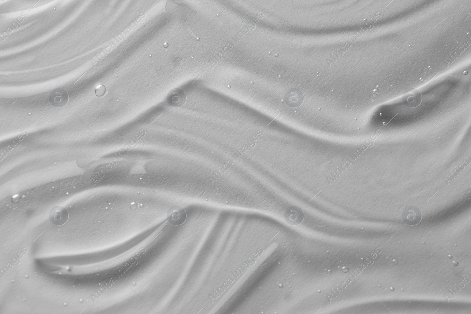 Photo of Texture of transparent shower gel on white background, closeup