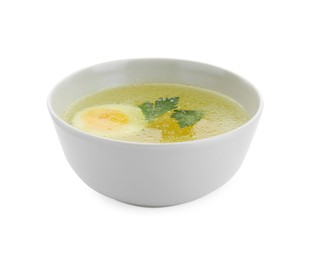 Delicious chicken bouillon with egg and parsley in bowl on white background