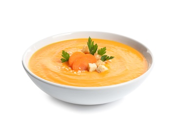 Dish with carrot cream soup on white background. Healthy food