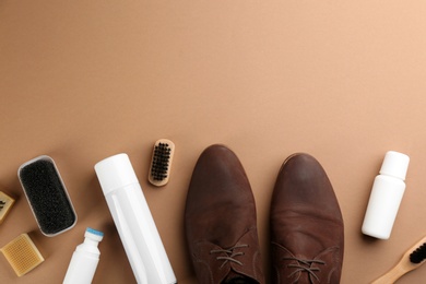 Stylish footwear with shoe care accessories on brown background, flat lay. Space for text