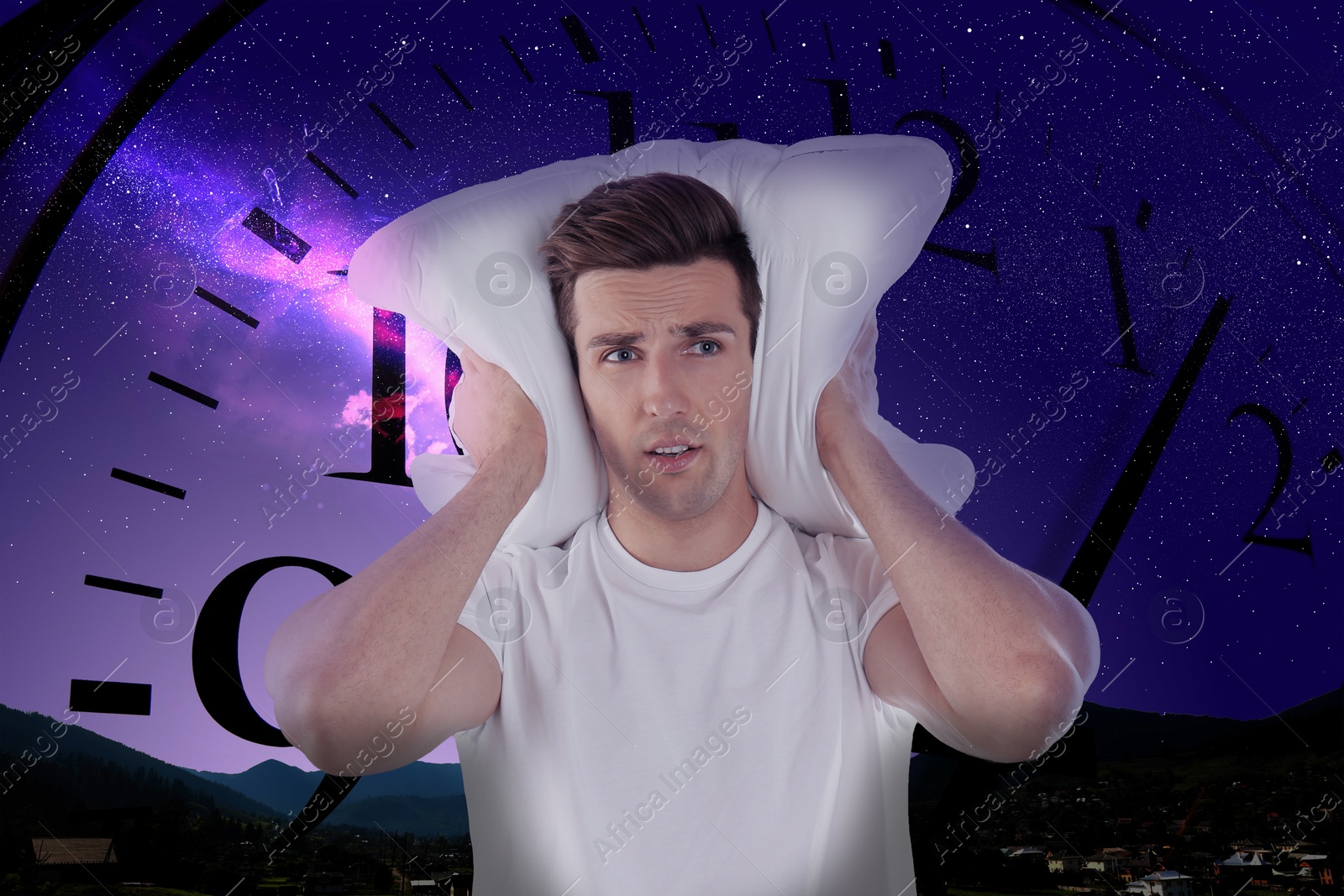 Image of Young man in pajamas with pillow and beautiful starry sky at night and clock on background. Sleep deprivation