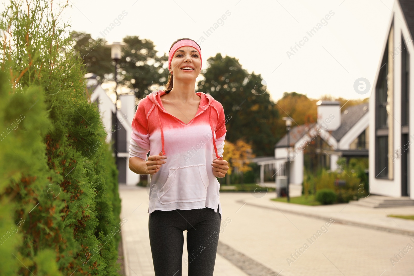 Photo of Beautiful sporty woman running on street. Healthy lifestyle