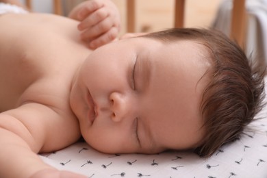 Cute little baby sleeping in crib at home, closeup