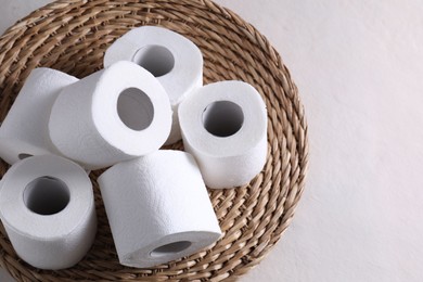 Photo of Toilet paper rolls on white table, above view. Space for text