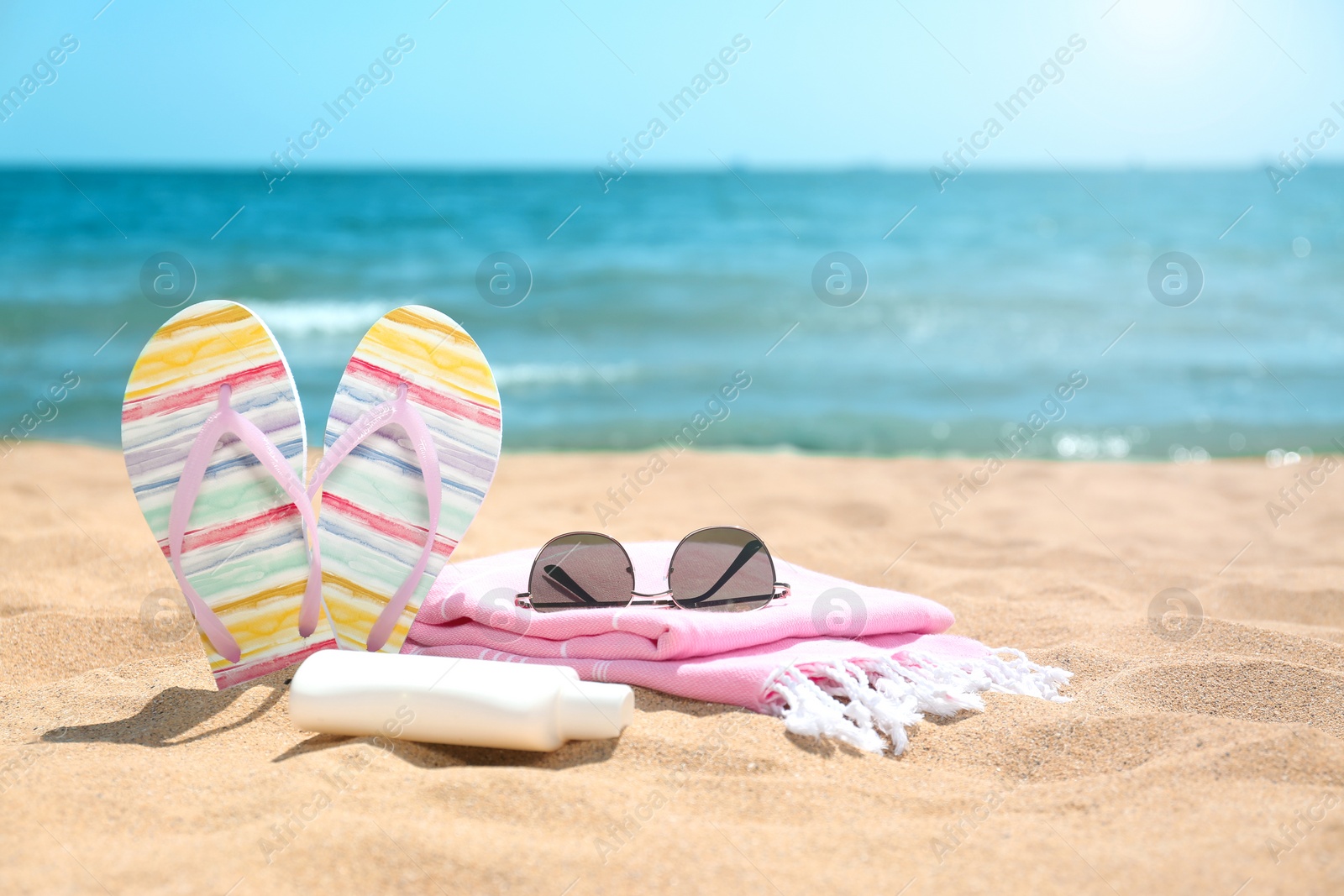 Photo of Set of different beach objects on sand near sea. Space for text