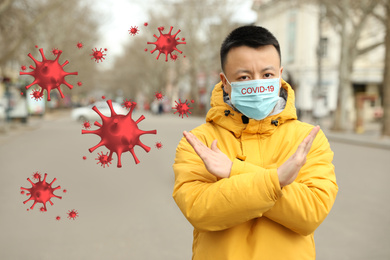 Image of Asian man wearing medical mask on city street. Virus outbreak