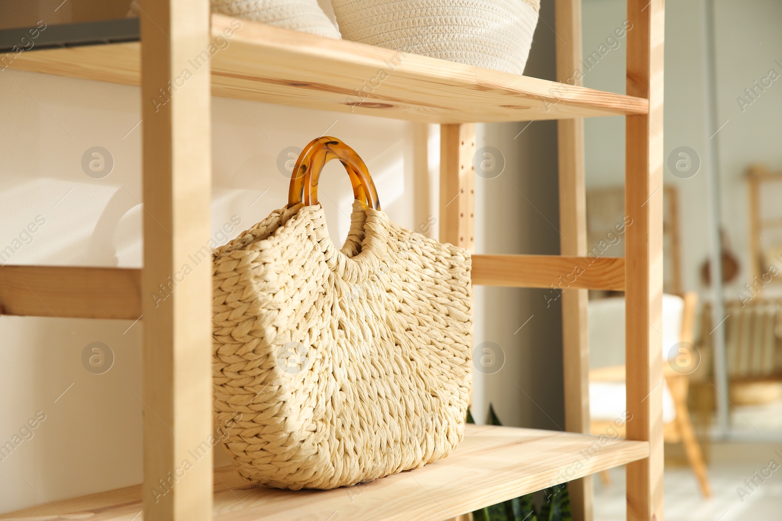 Photo of Stylish knitted woman's bag on shelf in boutique