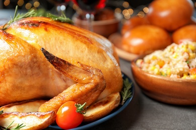 Photo of Delicious roasted turkey for traditional festive dinner on table, closeup