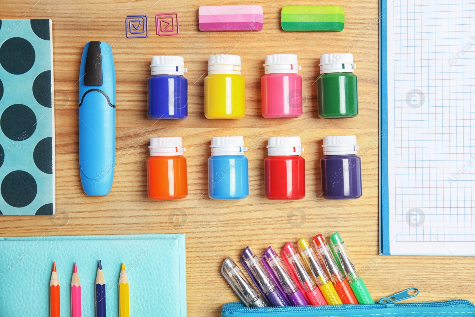 Photo of Different school stationery on wooden background, flat lay