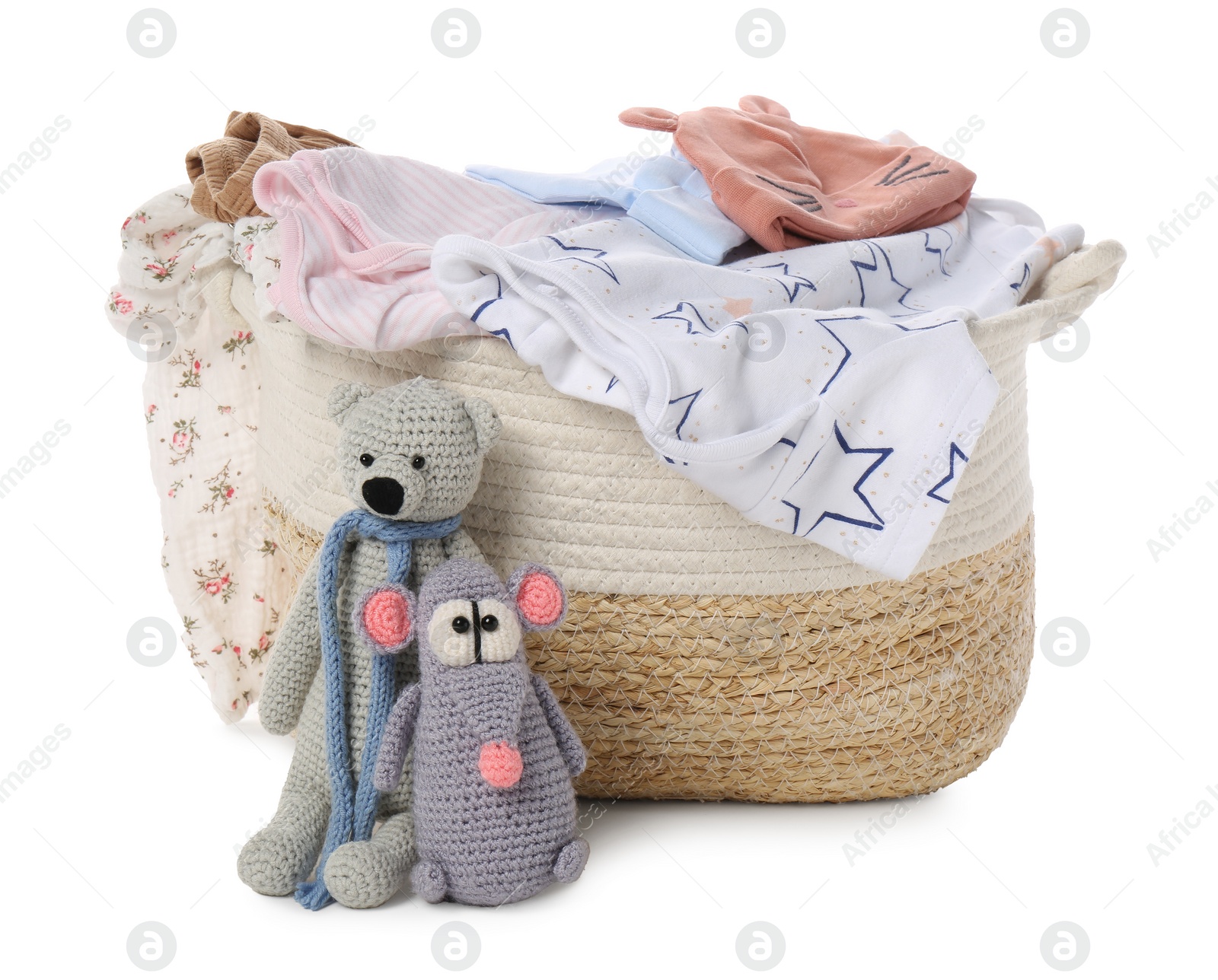 Photo of Laundry basket with baby clothes and soft toys isolated on white