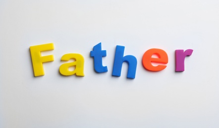 Photo of Word FATHER of magnetic letters on white background, top view
