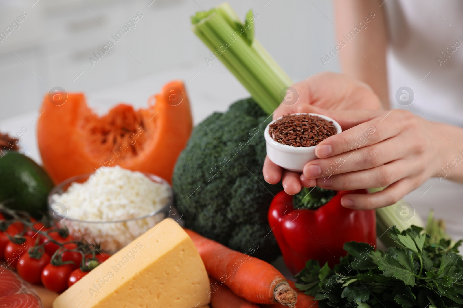 Photo of Woman with bowl of flax seeds on blurred background, closeup. Keto diet