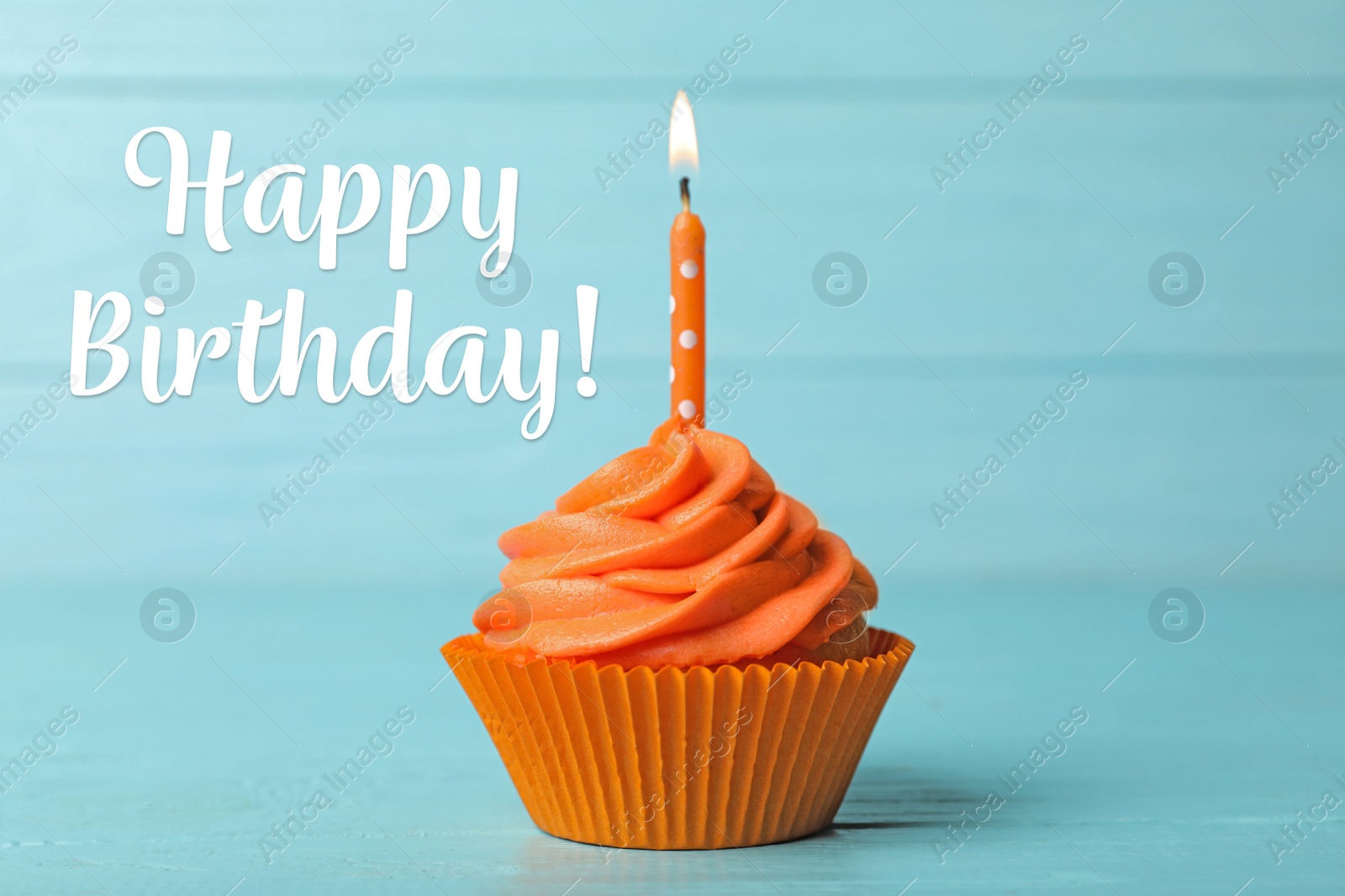 Image of Happy Birthday! Delicious cupcake with burning candle on blue wooden background