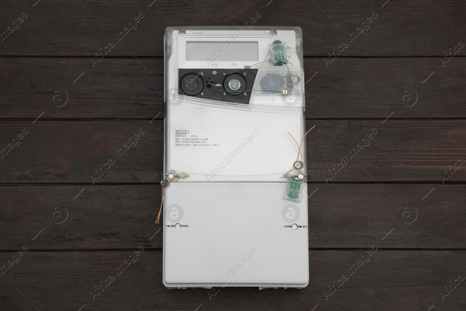 Photo of Electric meter on wooden background, top view. Measuring device