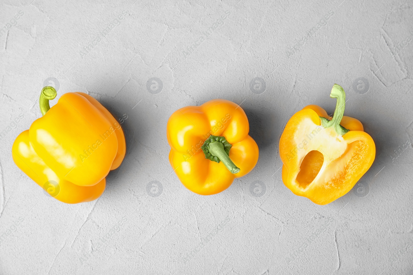 Photo of Raw ripe paprika peppers on grey background, top view