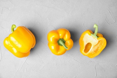 Photo of Raw ripe paprika peppers on grey background, top view