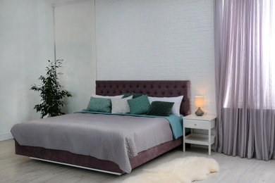 Contemporary room interior with comfortable double bed