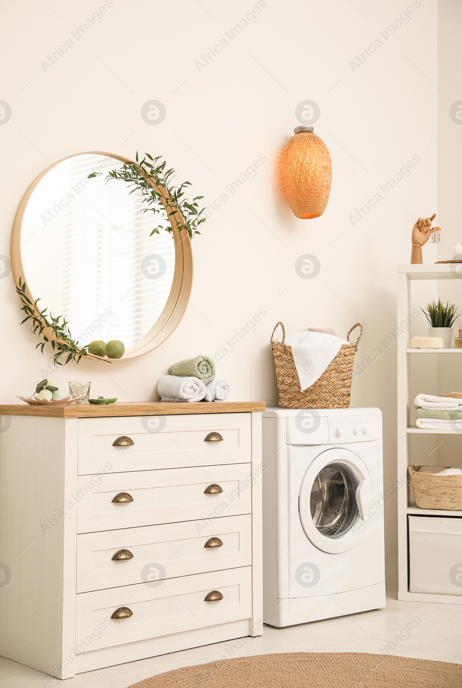 Photo of Round mirror on white wall in modern bathroom