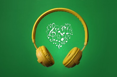 Yellow headphones and heart shape made of music notes with treble clef on green background