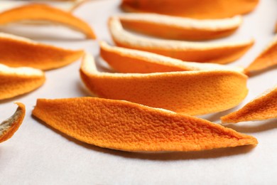 Photo of Many orange peels preparing for drying on white table, closeup