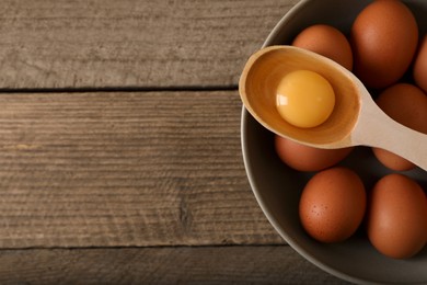 Raw chicken eggs on wooden table, top view. Space for text