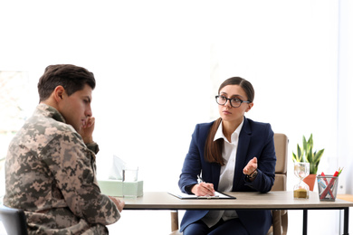 Psychotherapist working with male military officer in office