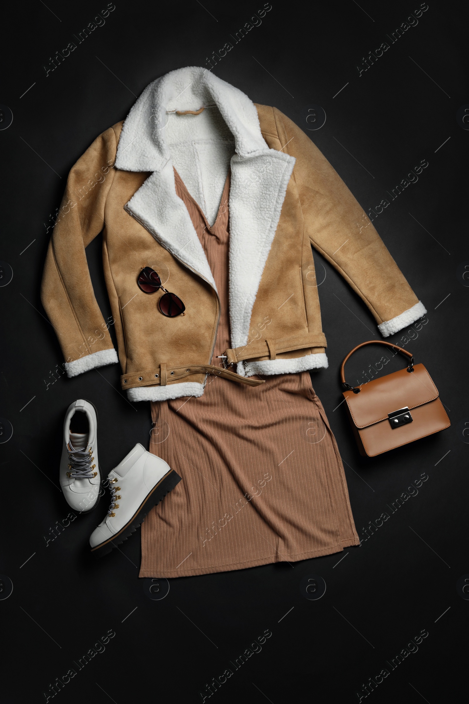 Photo of Stylish boots, new clothes and accessories on black background, flat lay