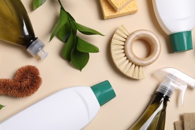 Flat lay composition with different cleaning supplies on beige background