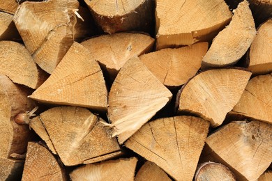 Photo of Pile of chopped firewood as background, closeup