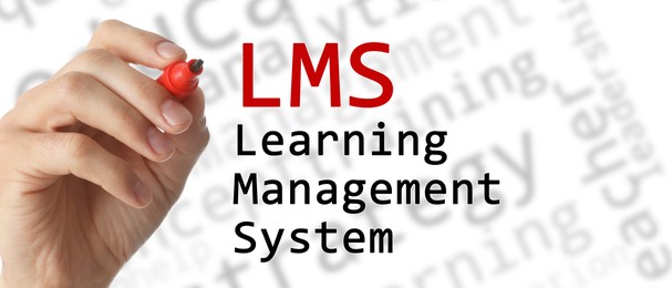 Image of Learning management system. Woman writing abbreviation LMS on glass board, closeup. White background, banner design