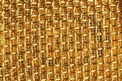 Image of Metal mesh of golden microphone as background, closeup