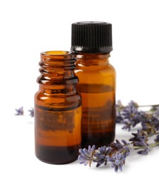 Essential oil and lavender flowers on white background