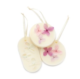 Beautiful scented sachets with flowers on white background, top view