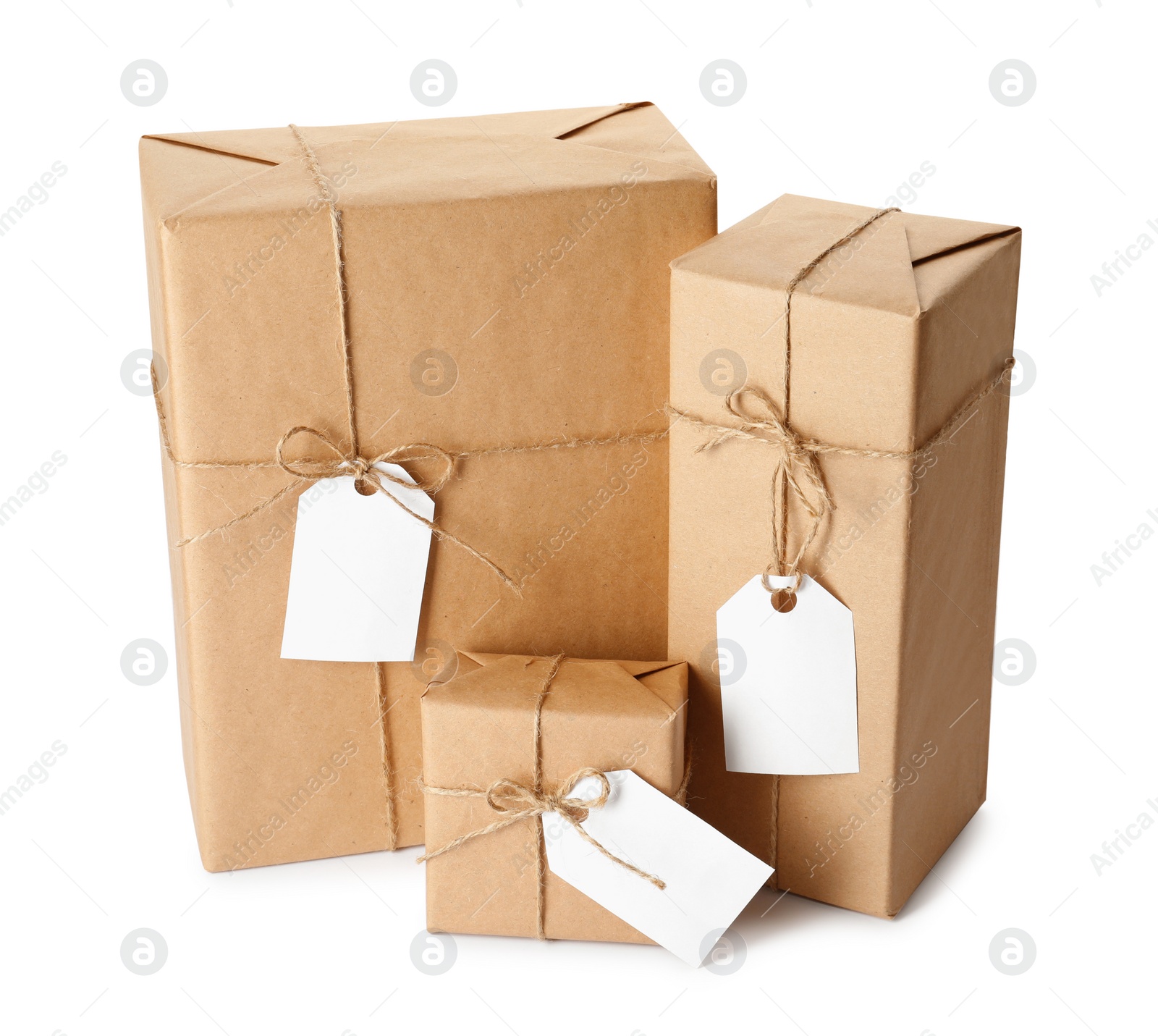 Photo of Gift boxes wrapped in kraft paper with tags on white background