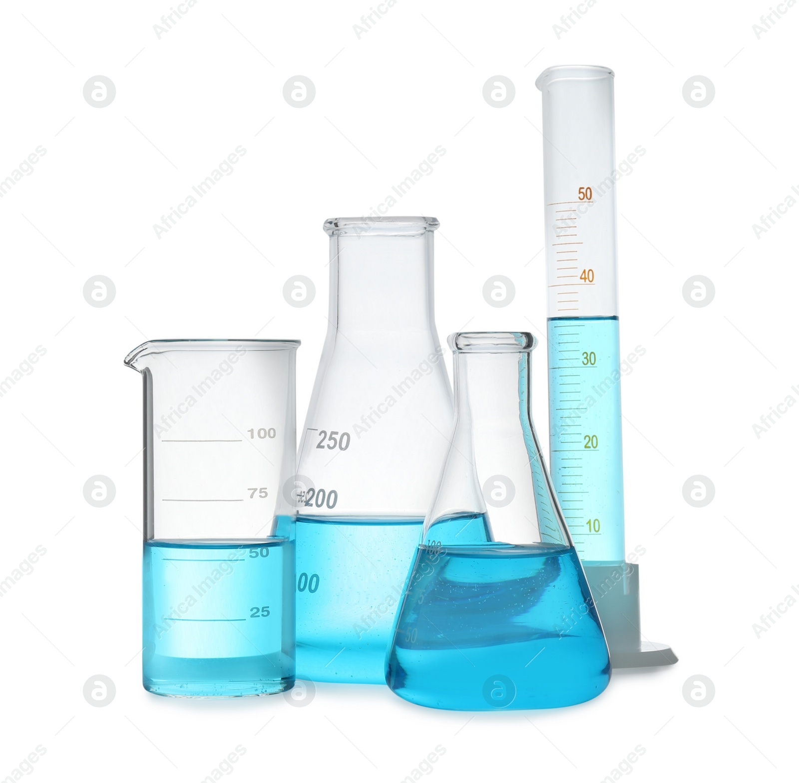 Photo of Different laboratory glassware with light blue liquid isolated on white