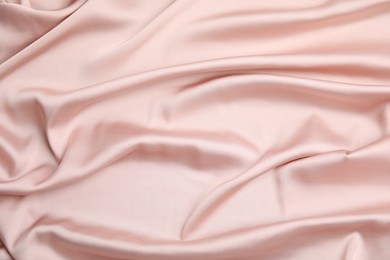 Photo of Texture of delicate pink silk as background, top view