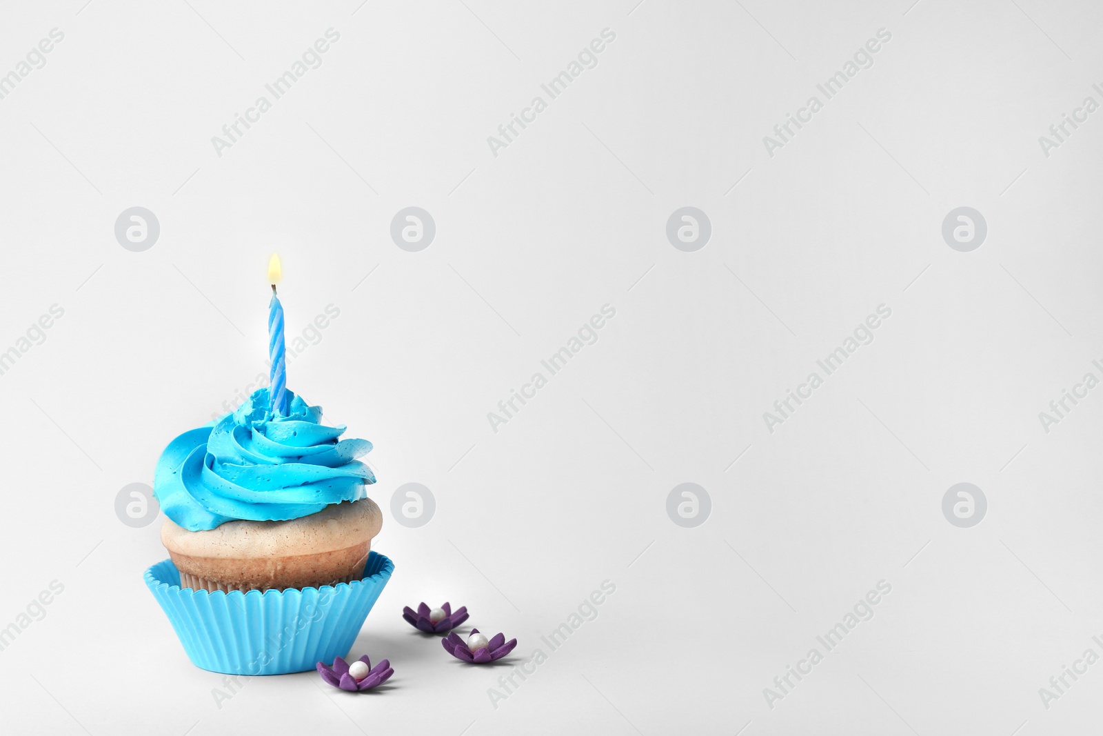 Photo of Birthday cupcake with candle on white background