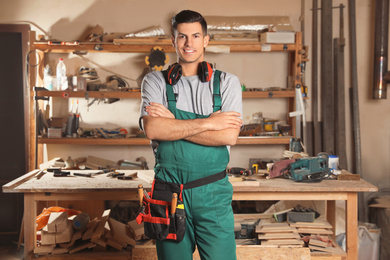 Professional carpenter with set of tools in workshop