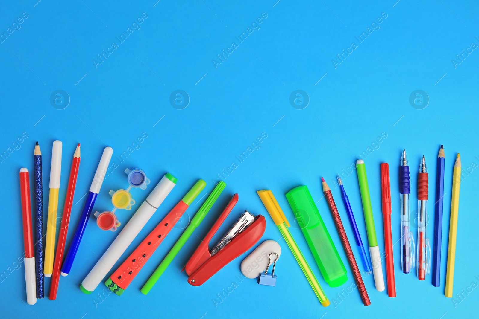 Photo of Flat lay composition with different school stationery on light blue background, space for text. Back to school