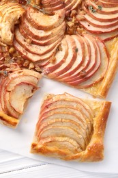 Freshly baked apple pie on white wooden table, top view