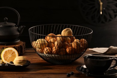 Aromatic walnut shaped cookies and tea on wooden table. Homemade pastry carrying nostalgic atmosphere