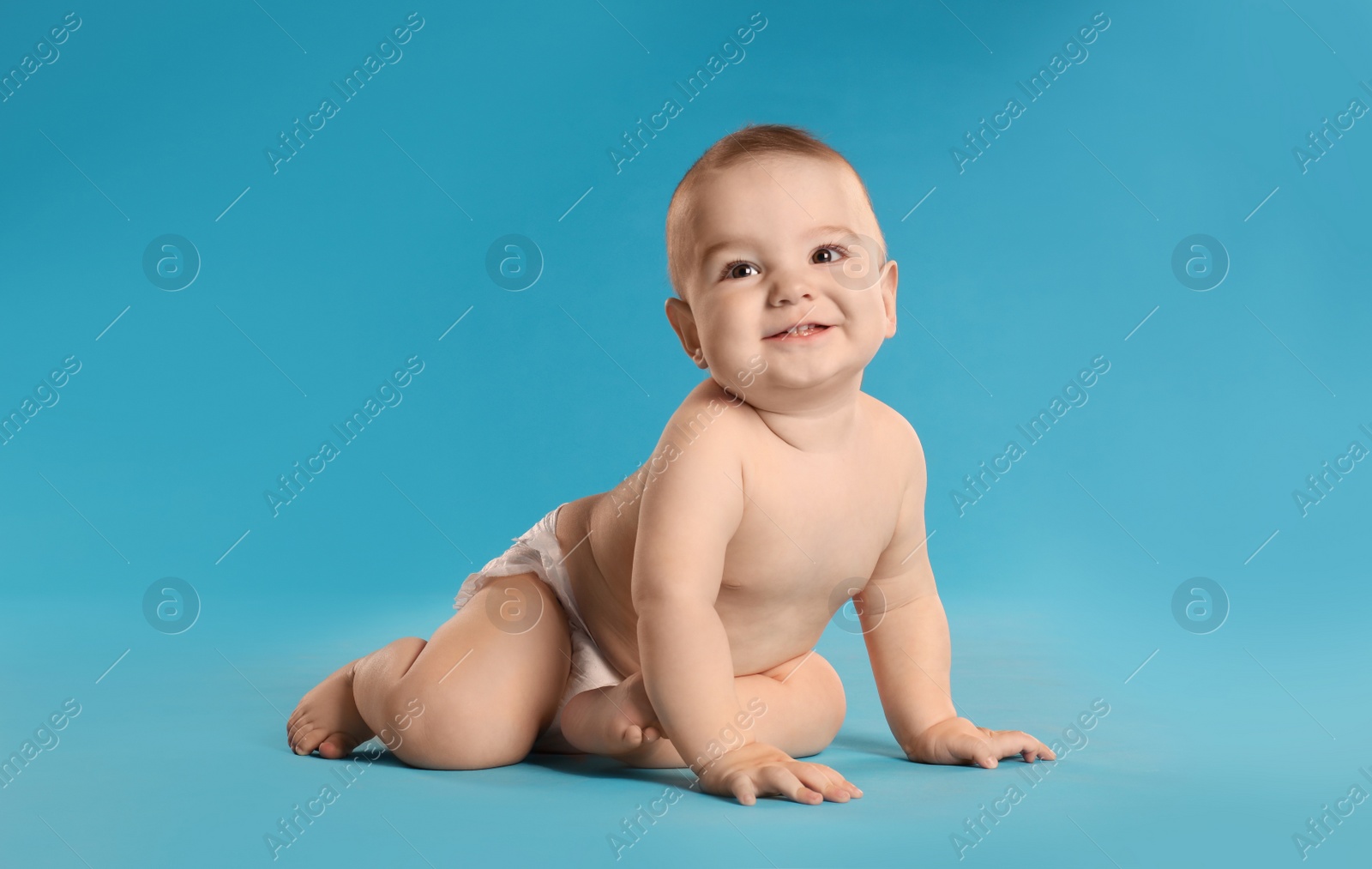 Photo of Cute little baby in diaper on light blue background. Space for text