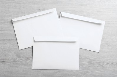 White paper envelopes on wooden table, flat lay